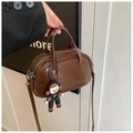 Retro dark brown round pillow bag in glossy leather with a cute boy doll charm - Coffee with Pendant