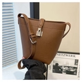 Close-up of brown litchi pattern leather bucket bag with silver buckle detail - Brown
