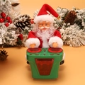 Electric musical Santa Claus toy playing drums with festive green base and warm background - Green Drumming Santa