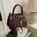Chocolate brown faux leather crossbody bag with glossy finish and gold key charm accessory - Brown