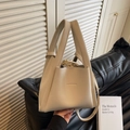 Minimalist beige pebble leather bucket bag with top handles and a detachable strap - Off White