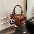 Dark brown shiny leather Boston bag with embossed lettering and horse charm - Coffee with Pendant