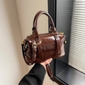 Deep chocolate brown Boston handbag in glossy finish with embossed letter detailing - Brown No Pendant