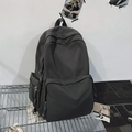Sleek dark grey minimalist backpack with multi-pocket design on industrial metal shelf - Dark Gray