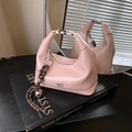 Pink glossy patent leather dumpling handbag with chic metal bell pendant accessory - Pink