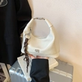 Chic off-white patent leather hobo bag with silver hardware and braided tassel accent - White