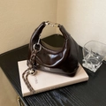 Dark brown patent leather hobo bag with vintage metal clasp and decorative knot charms - Brown