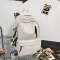 Off-white canvas laptop backpack with multiple pockets and brown leather brand tag - White