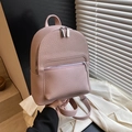 Pink mini faux leather backpack with litchi texture and silver hardware in soft light - Pink