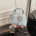 Retro baby blue mini bowling bag with decorative belts and dual top handles - Blue