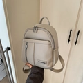Chic taupe litchi texture leather backpack with double zippers and stylish front pocket - Gray