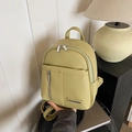 Pistachio green faux leather mini backpack featuring pebble texture and silver zippers - Yellow