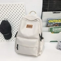 Minimalist beige water-resistant nylon backpack with a brown leather logo and side pockets - White