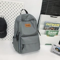 Minimalist grey nylon travel backpack for students featuring orange logo and multi-pockets - Gray