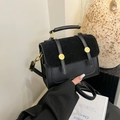 Classic black leather and suede crossbody bag with gold accents and a chic top handle - Black