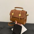Brown vintage messenger bag with sleek top handle and golden round metal buckles - Brown