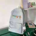 Light grey blue nylon backpack featuring colorful pom-poms and a plush cartoon pendant - Blue with Charm
