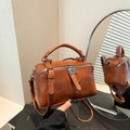 Vintage brown leather bucket bag with double zippers and top handle for crossbody wear - Brown