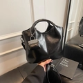 Chic black bucket bag in oil wax leather with a matching mini bag charm decoration - Black with Pendant