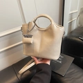 Beige bucket bag in textured PU leather with adjustable strap and charm detail - Apricot With Pendant