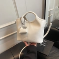 Creamy white bucket bag in lychee pattern PU leather with a mini bag charm accessory - White with Pendant