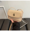 Detail of light khaki crossbody bag featuring metal turn-lock and minimalist leather texture - Khaki