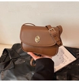 Detail of caramel brown PU leather crossbody bag with golden oval twist lock and logo - Brown