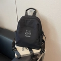 Sac à dos en nylon noir minimaliste avec motif de chat et bretelles sur un bureau - Noir
