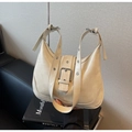 Detail of cream shoulder bag featuring a large metal buckle and wide strap with eyelets - Off White