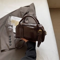 Deep brown Boston bag in glossy finish with round handles and adjustable strap - Coffee