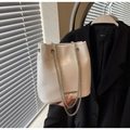 Detail of white pleated PU bucket bag with silver chunky chain and metal bar accent - Off-white