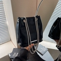 Glossy black bucket shoulder bag with silver double chain straps and metal trim - Black