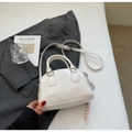 Minimalist white pillow bag with double handles and metal charm in a lifestyle setting - Off-white (No Pendant)