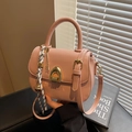 Borsa a sella rosa in pelle opaca con chiusura dorata e ciondolo intrecciato - Rosa