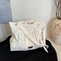 Minimalist white pleated tote bag with black Romance label and knotted shoulder strap - White