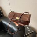 Dark brown high-gloss leather baguette underarm bag with gold metallic buckle clasp - Brown