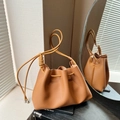 Karamellfarbene Kordelzug-Beuteltasche aus Leder mit Knotengurt und silberner Perle - Braun