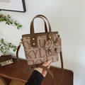 Brown lucky letter print bucket bag with leather handles and bear pendant - With Charm / Brown