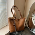 Classic brown leather tote bag with stylish vertical strap and dark knot charm detail - Brown with Pendant