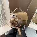 Beige square handbag with metallic twist lock and brown teddy bear charm accessory - With Charm / Khaki