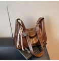 Detail of vintage brown PU leather hobo bag with woven knots and metal charm pendant - With Pendant / Brown