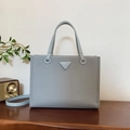 Light blue-grey woven tote bag with triangular metal logo and detachable shoulder strap - Blue