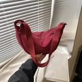 Burgundy crescent nylon crossbody bag with textured fabric and matching wide shoulder strap - Red