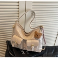 Dettaglio della borsa beige con doppie tasche con fibbia e ciondolo a orsetto - Con Ciondolo / Bianco Sporco