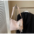 Close-up of pink hobo bucket bag with lace bow accessory and woven strap detail - Pink