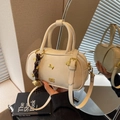 Creamy white bowling handbag with golden puppy charm and brown checkered pendant - With Pendant / Off White