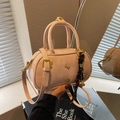 Pink matte leather bowling bag with gold bone charm and woven strap detail - With Pendant / Pink