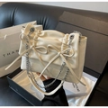 Detalle de bolso bandolera plisado crema con lazos y correa de cadena plateada - Blanco Roto