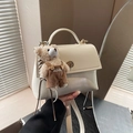 Chic cream white leather crossbody bag with cute teddy bear charm and gold clasp hardware - With Charm / White
