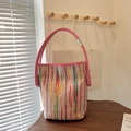 Pink woven bucket bag with colorful vertical stripes and leather handles - Pink